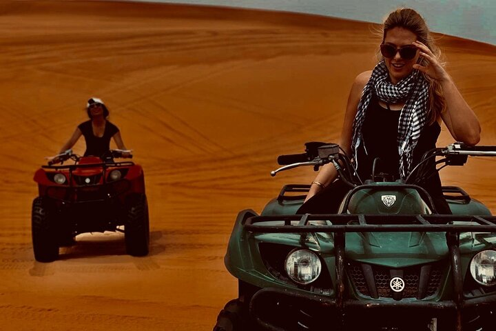 Dare to conquer the stunning red dunes of the Lahbab Desert on an ATV while enjoying a unique blend of adventure and cultural experiences under the vast desert sky.